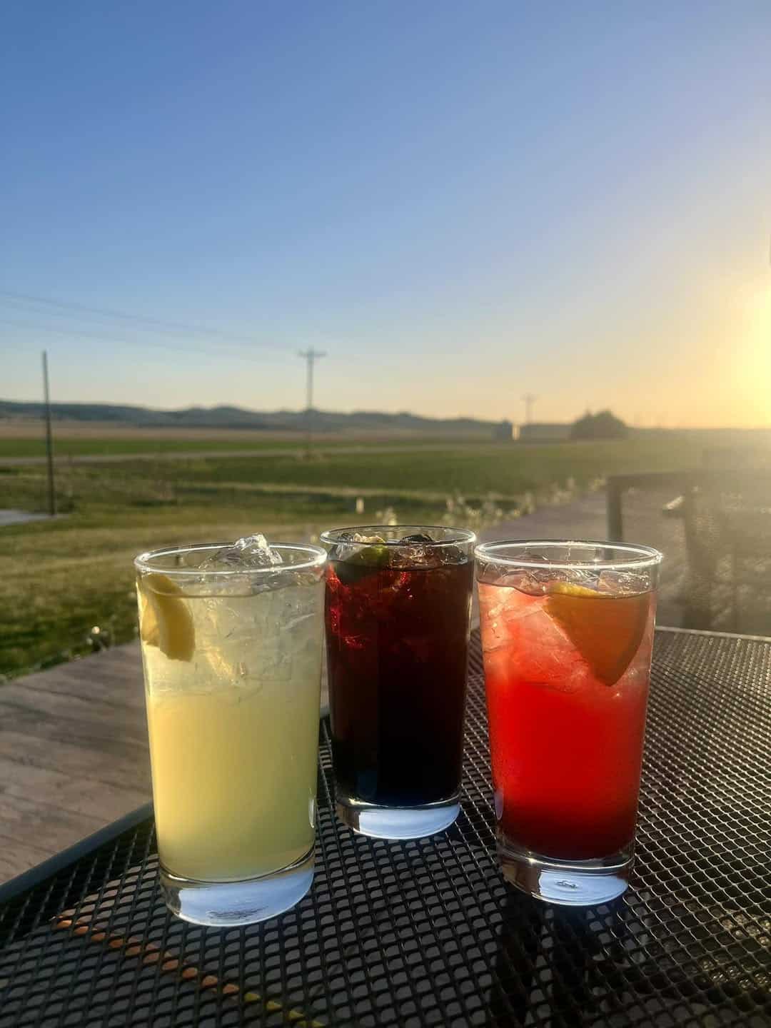 Three sangrias on a patio table at sunset